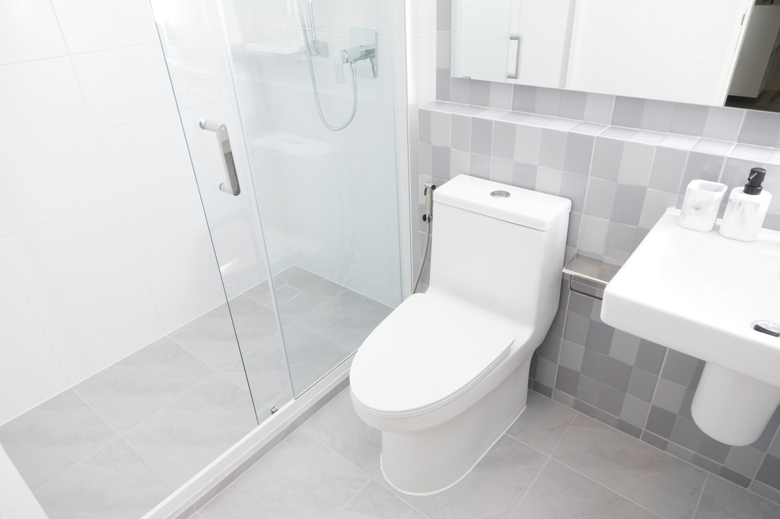 Bright bathroom with toilet, sink and glass shower