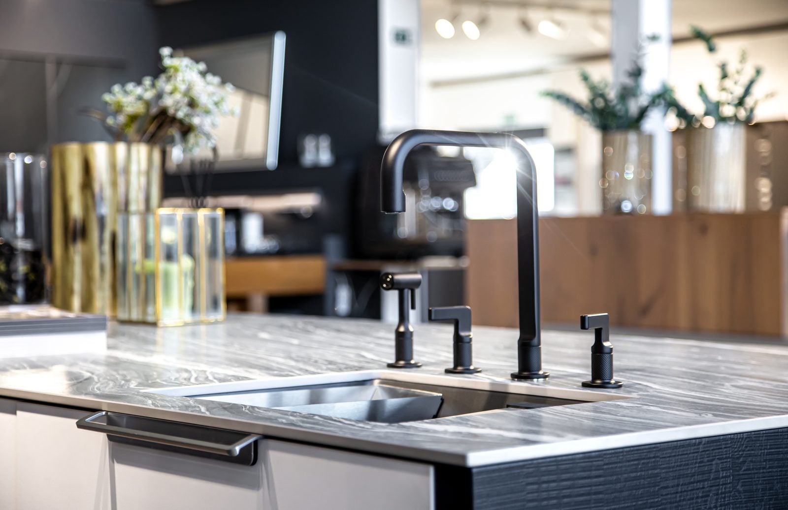 Black kitchen faucet over a stainless steel sink